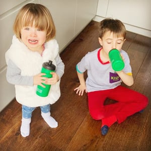 Coco and Rafa patiently drink from their English for Fun water bottles while they patiently wait for their new Homeschool teacher, mom!