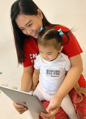 An English for Fun mom and her daughter proudly wear their uniforms to virtual preschool to see their friends.